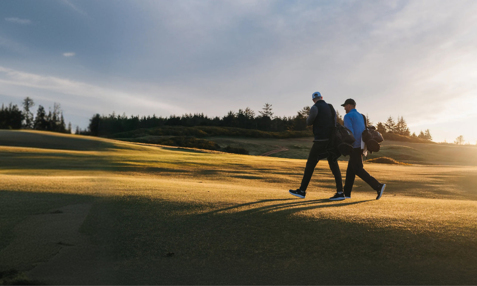 Golfers on course at sunset